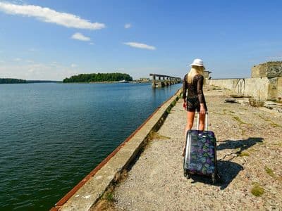 Blonde woman in white hat enjoying sunny day at Hara Submarine Base, Estonia.